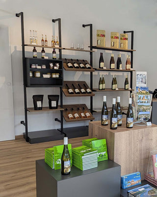 Wine store interior with shelves displaying wine bottles and packaging.